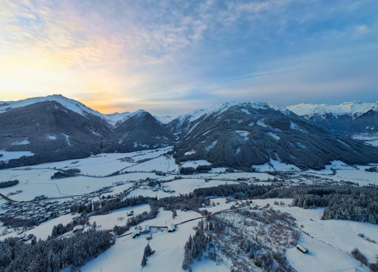 a scenic view of a winter landscape in the mountains