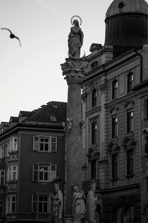 some statues on top of a tall building