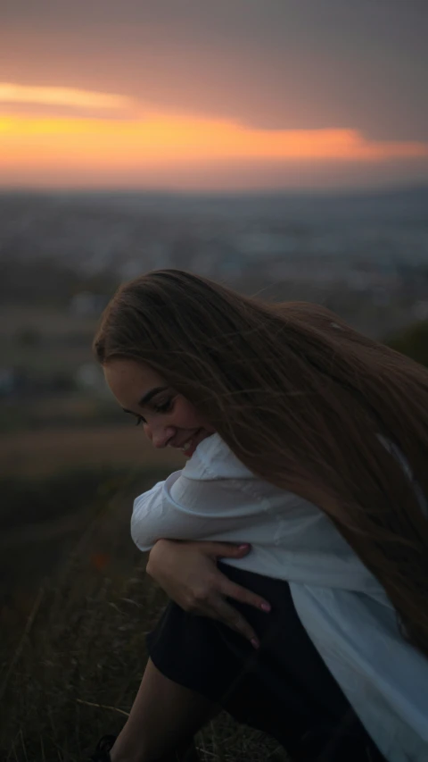  with red hair sitting and enjoying sunset