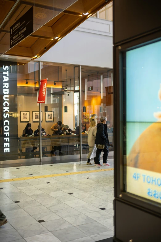 a store front with people walking in front