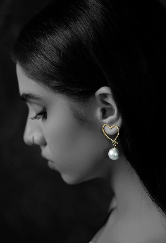 a woman's face with her ear wrapped in jewelry