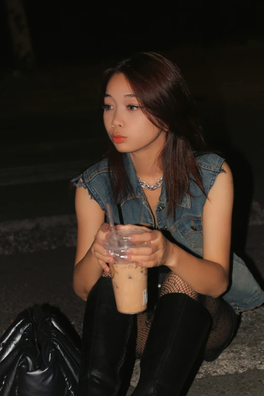 an asian woman with a drink in her hand