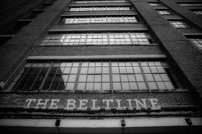 an old building with windows and a sign written underneath it