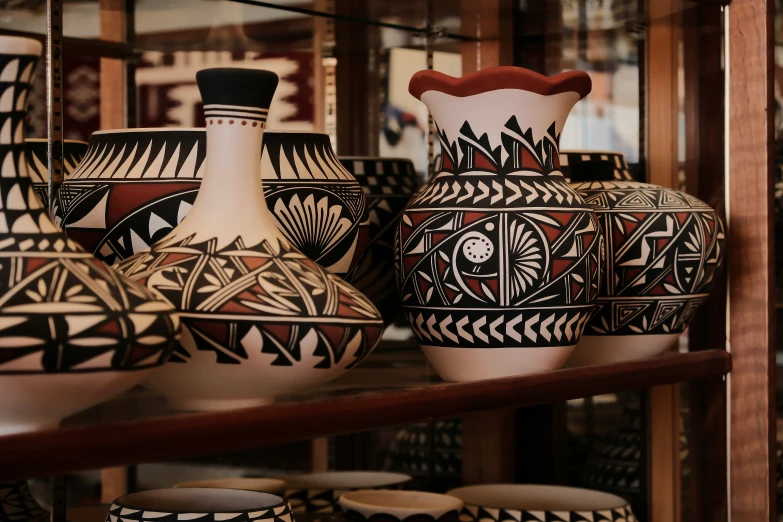 a close up of vases and jars on a shelf