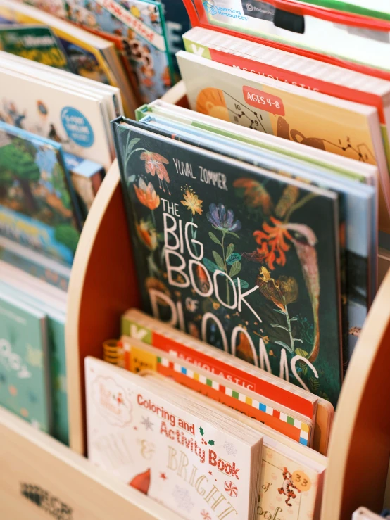 several children's books are stacked up in bins