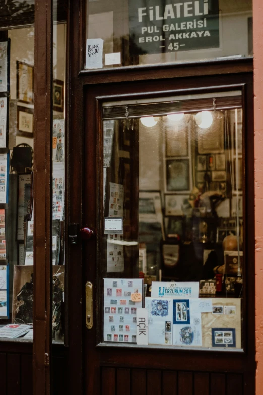 a store front with signs on the glass