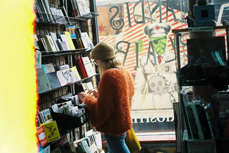 an older woman standing in front of a book store