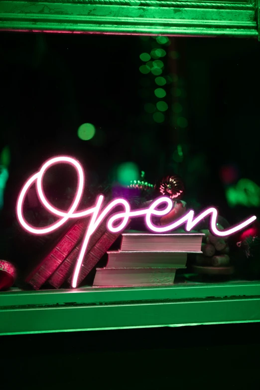 a open sign is lit up by purple and green light