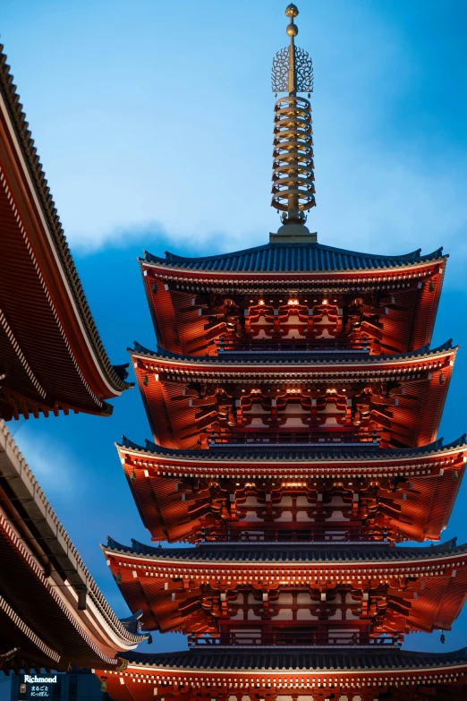 the view from underneath a tall building that is lit up