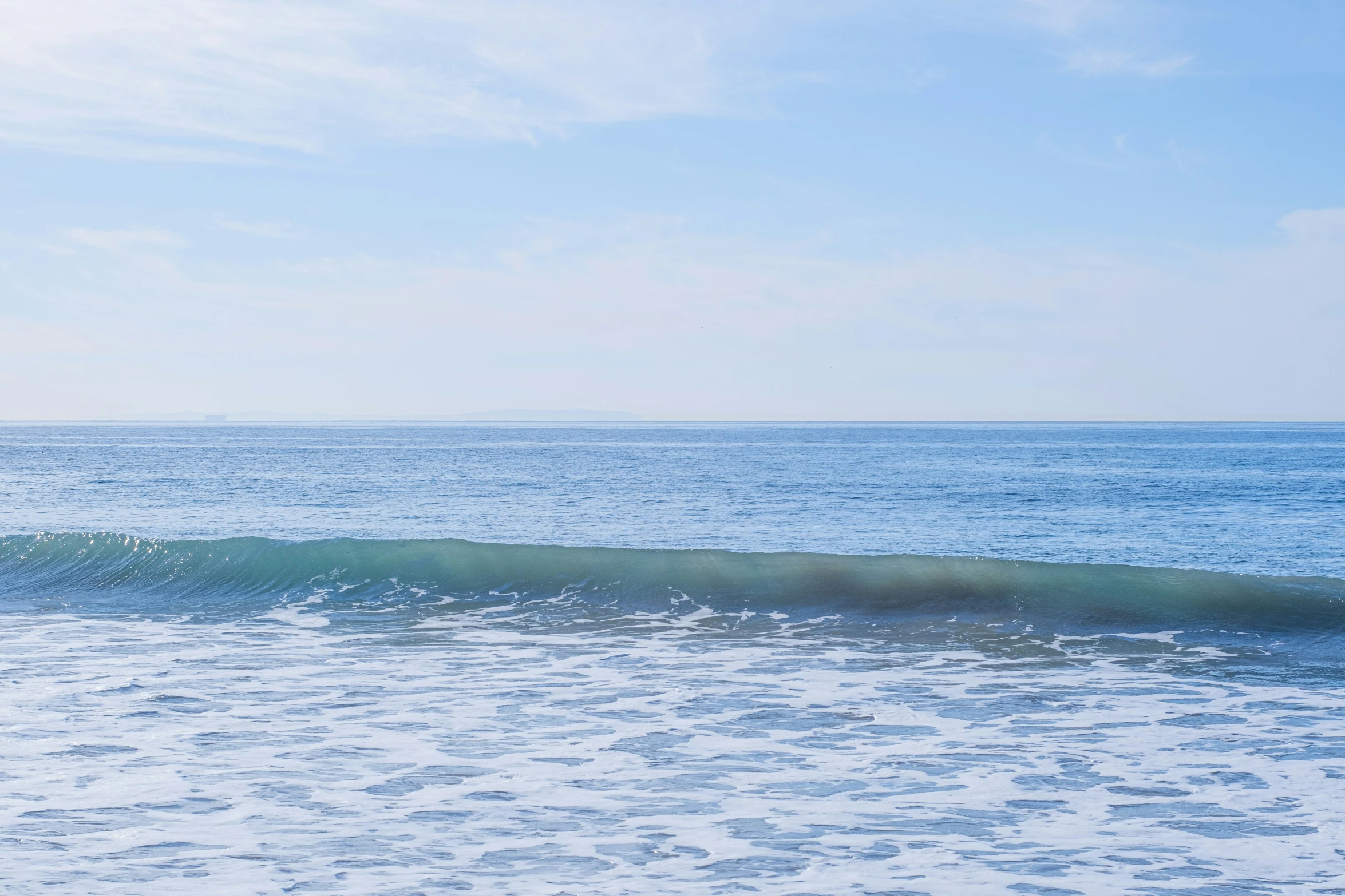 a person on a surfboard in the middle of a body of water