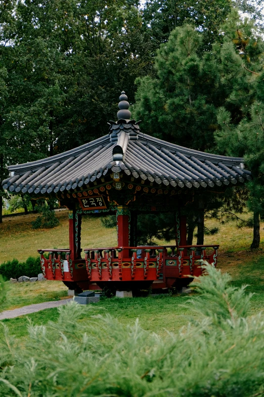 a pagoda sits with an orange bridge across from it