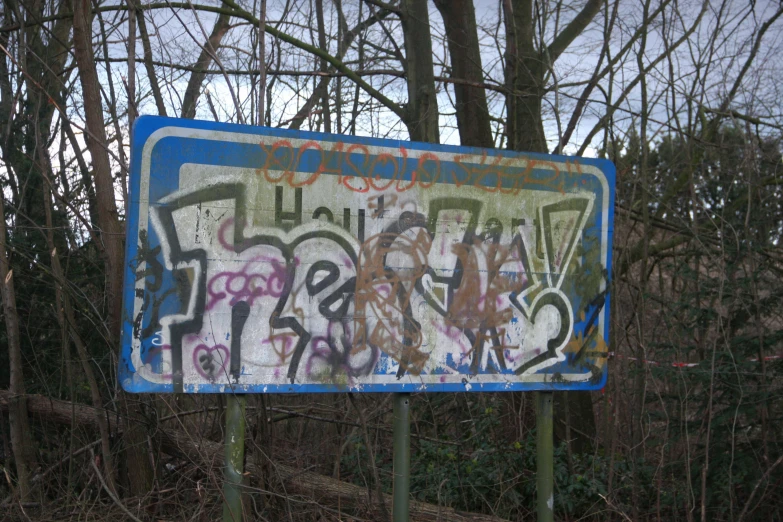 a street sign covered in lots of graffiti