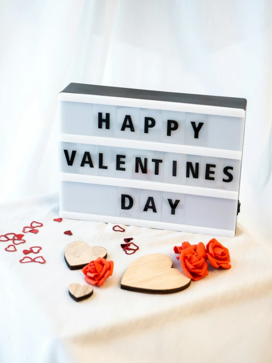 an electronic sign and some hearts on a table