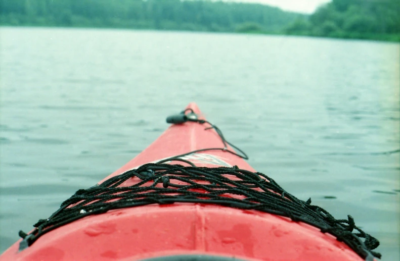 the top end of a red kayak is shown