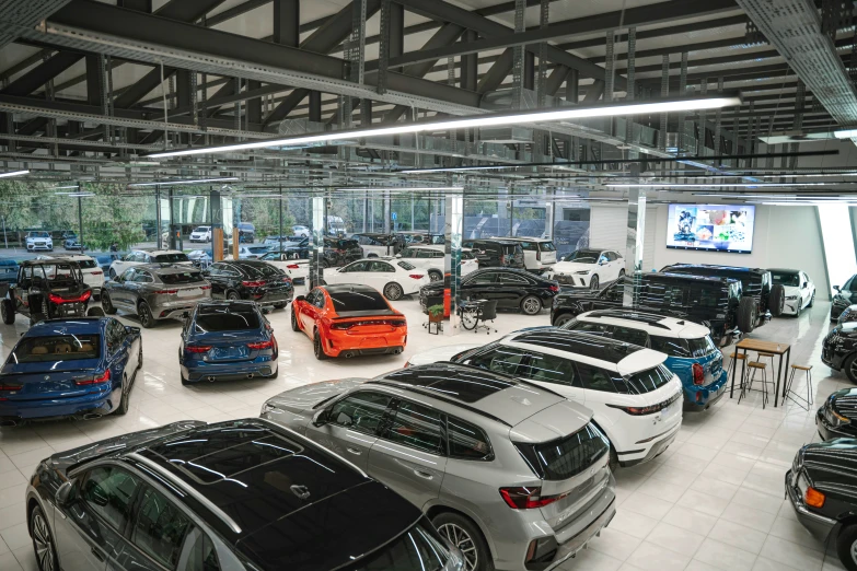 many vehicles in a large building with windows