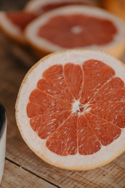 a round gfruit cut into small pieces next to some paint