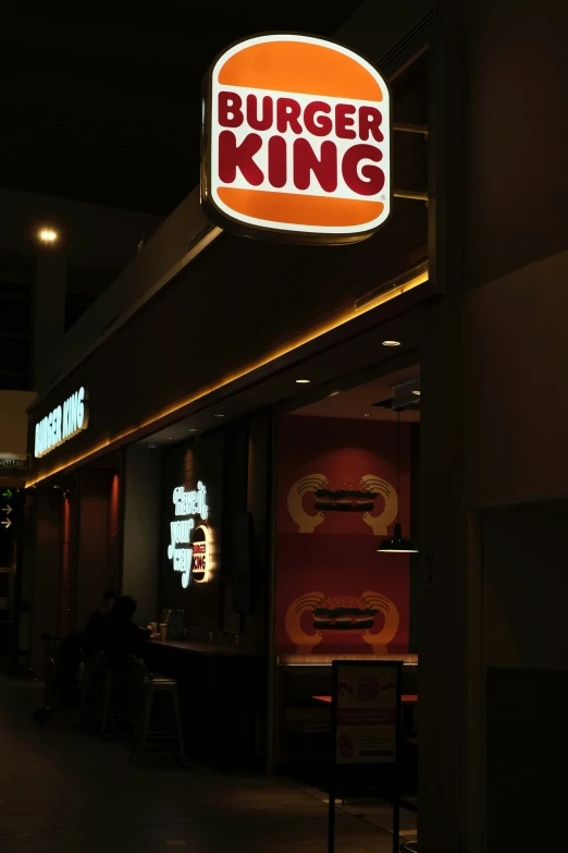 a large neon sign is lit up for diners