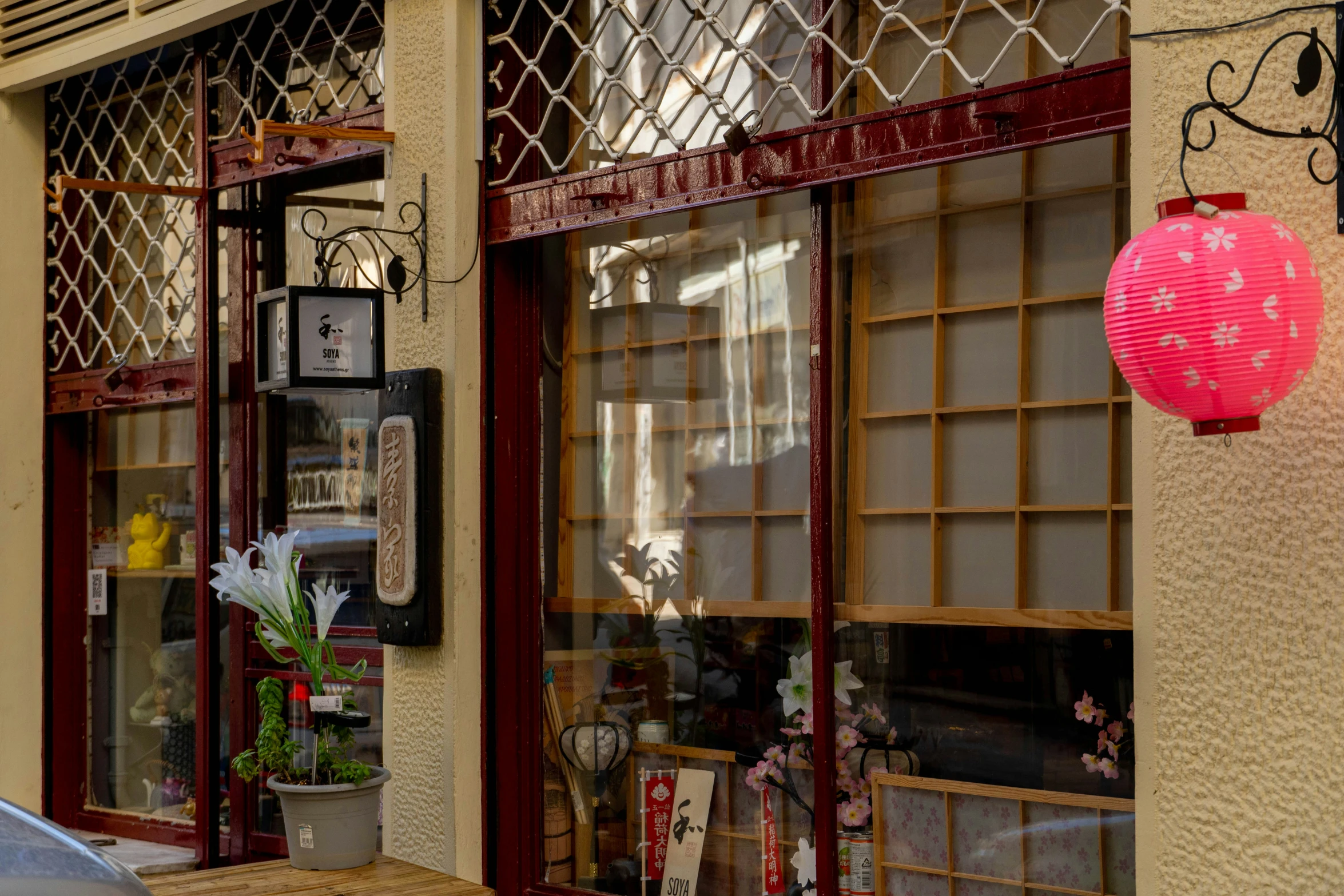 a pink paper lantern hanging over a street