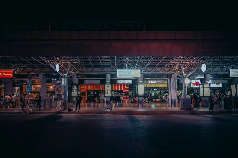 a night scene with people and lights at the store front