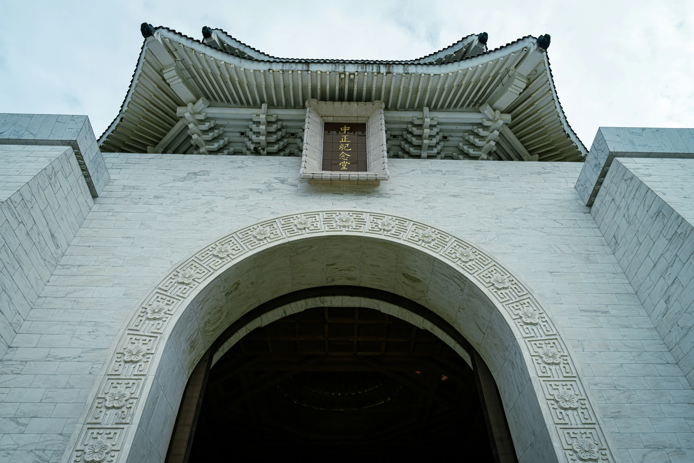 an arch leading into a very tall building