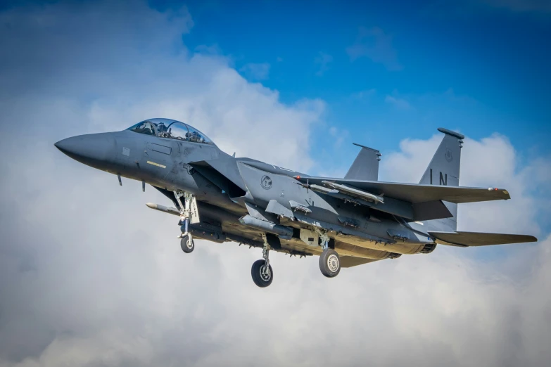 an fighter jet flies through the air during a cloudy day