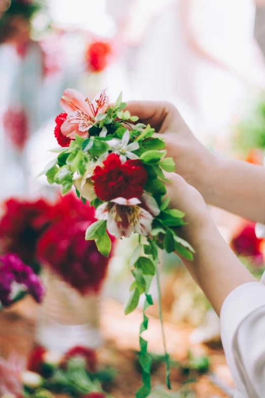 a woman arranging flowers in different arrangements for a bridal