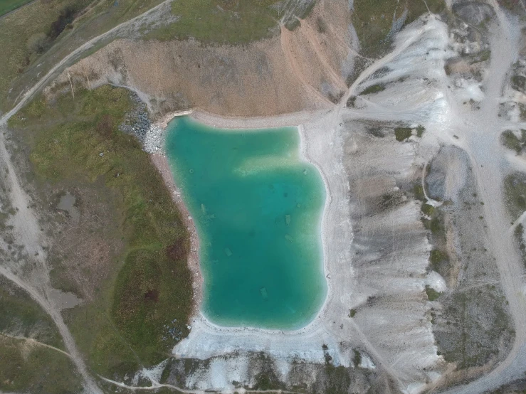 a lake surrounded by snow on the ground