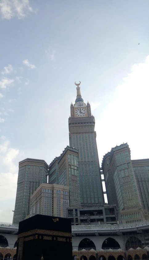 the large tall building has a large clock on it's side