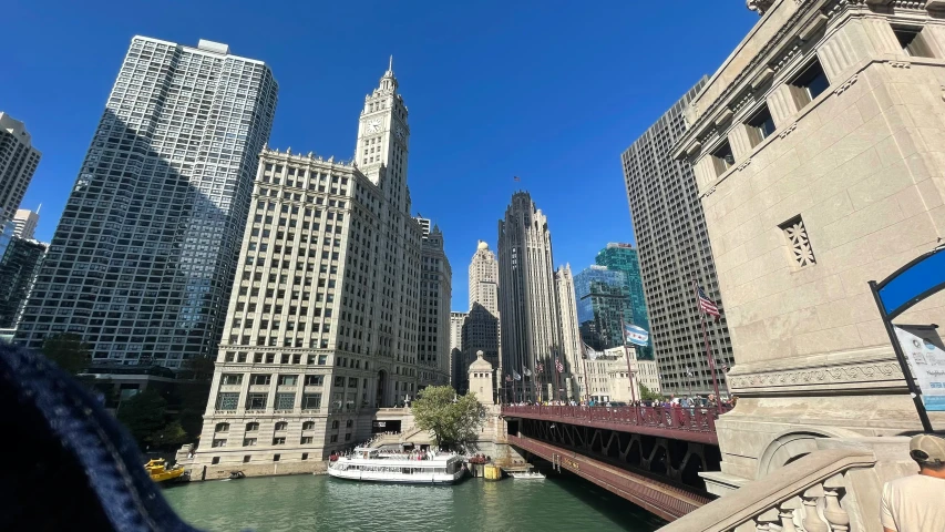 a long bridge over a river between buildings