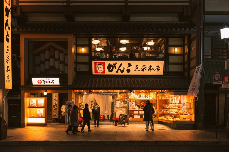 pedestrians are walking in an oriental marketplace at night