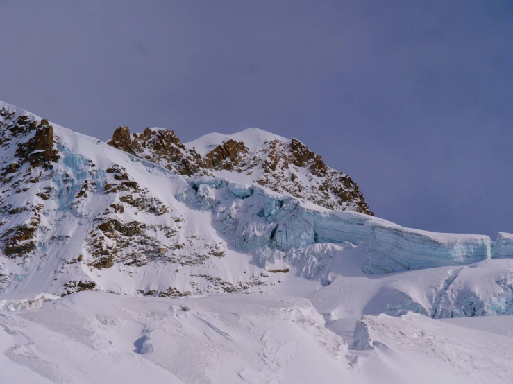 the mountain is covered in snow, while the skis are up