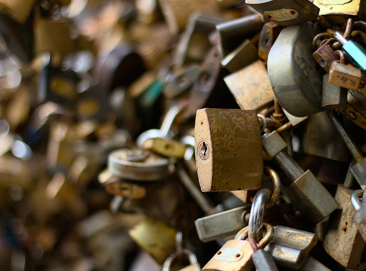 many padlocks are hanging from the wall