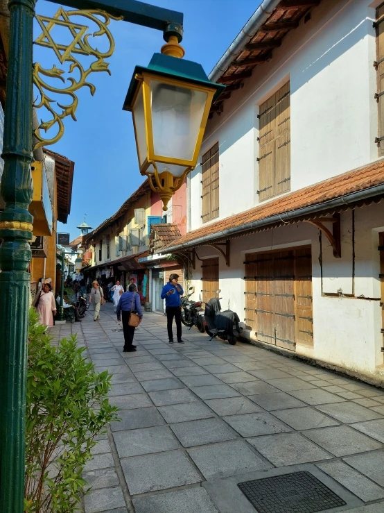 a row of brightly lit street lamps in the middle of an alley