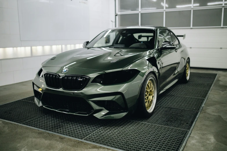 a grey bmw is shown with yellow accents