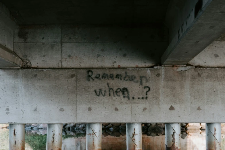 graffiti and a graffiti writing underneath a bridge