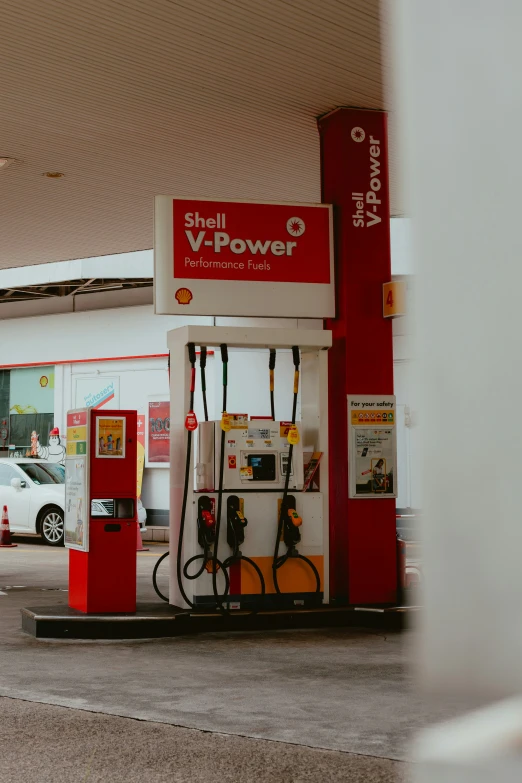 an old style shelling station with gas pumps