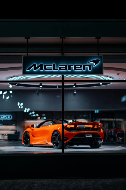 a car showroom with neon lights and cars in the background