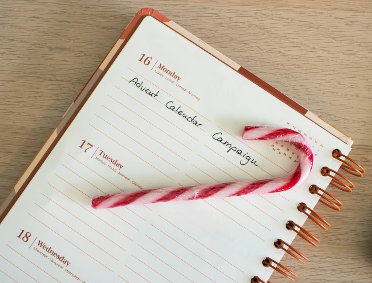 a candy cane laying on top of a paper