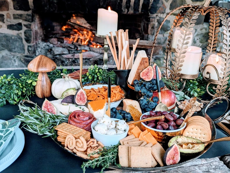 a platter of cheese, fruit and appetizers is set up for the guests