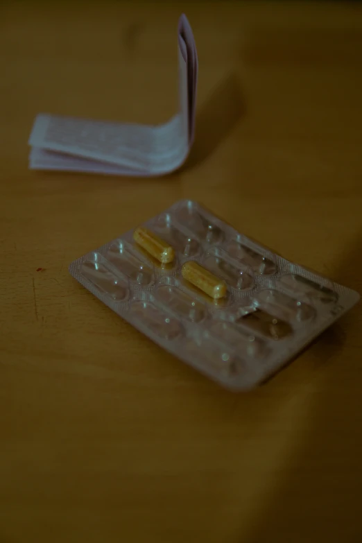 a close up of pills with an inhaler and white object