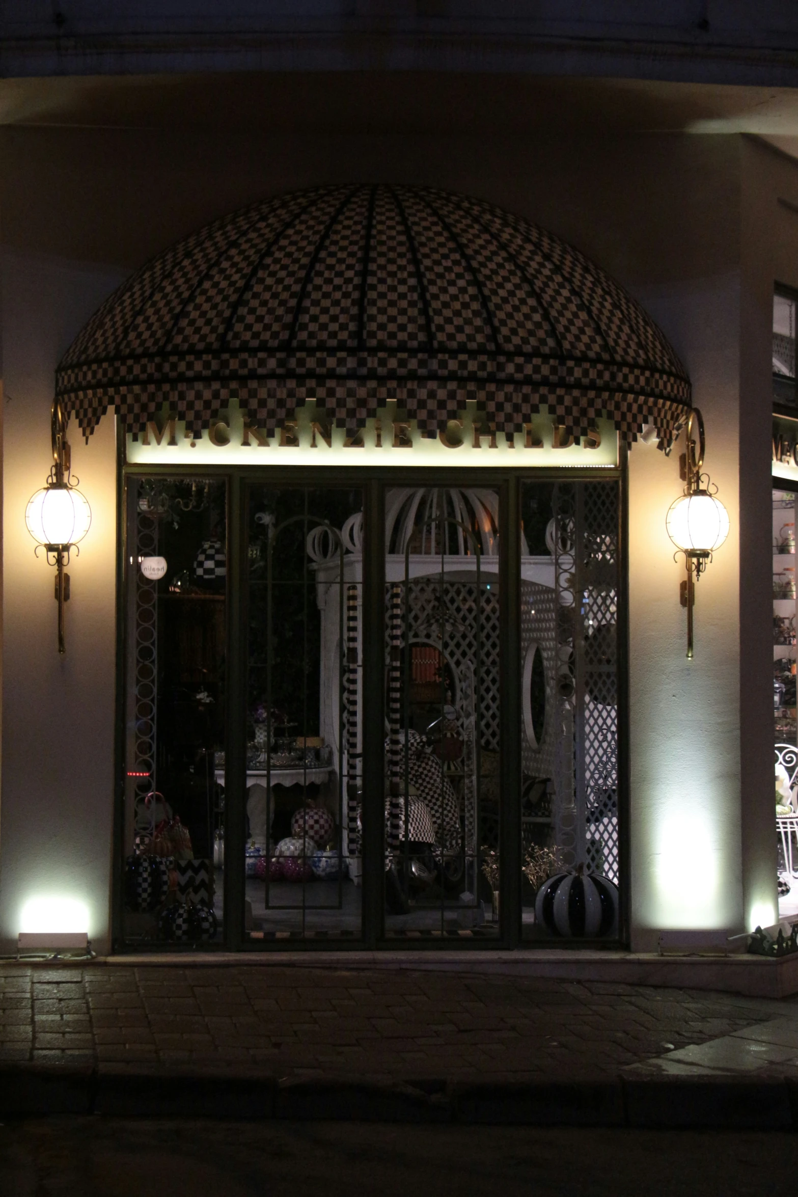 a window of a store front lit up at night