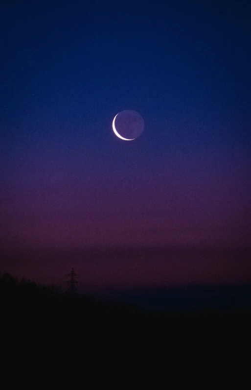 a crescent and the moon as seen from a distance