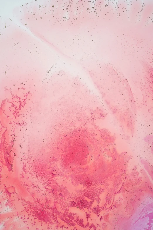 an abstract pink paint substance with a dark center