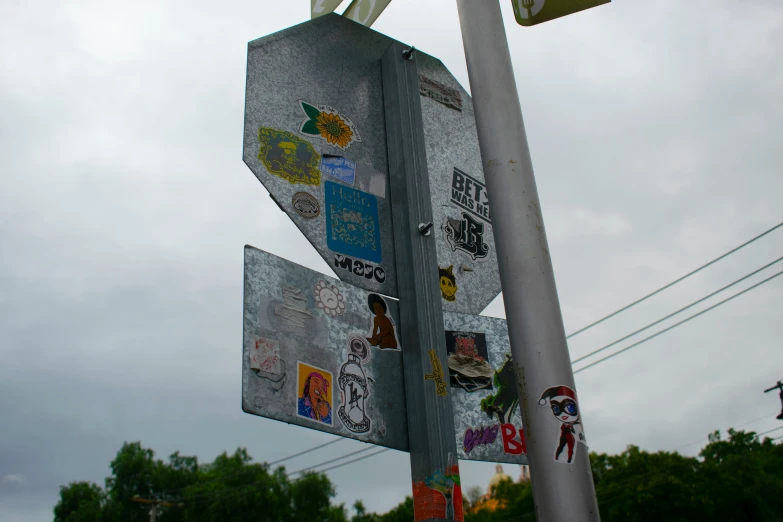 there is a sign covered with many stickers