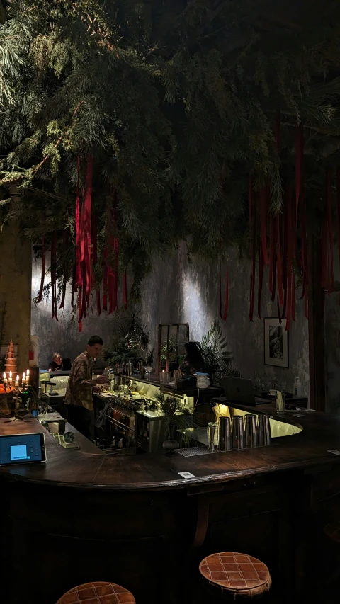 a dimly lit bar and stools in an old - fashioned restaurant