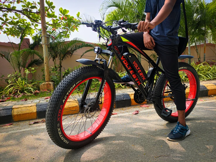 someone with a blue shirt is standing by their bike