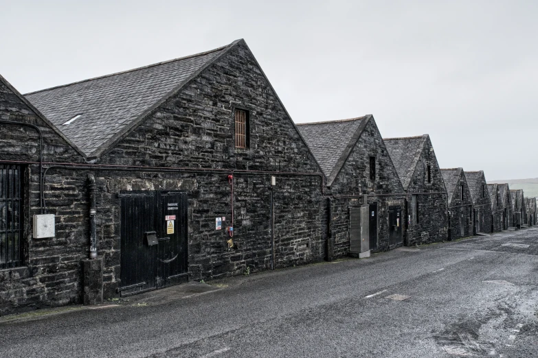 a row of grey brick buildings in the winter