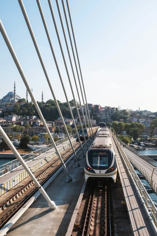 a train is traveling over a bridge next to the water