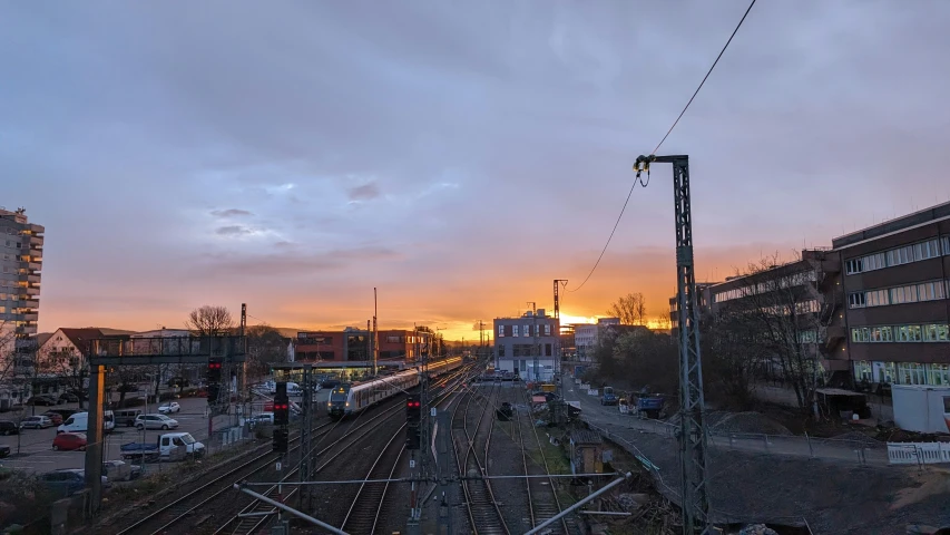 a train traveling down tracks next to tall buildings