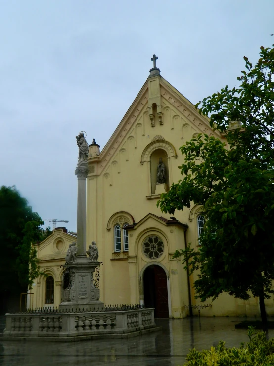 a church with statue on the front of it